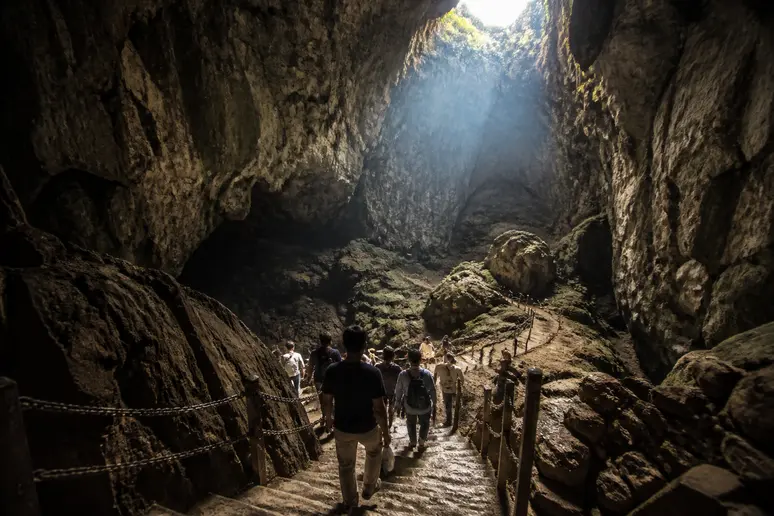 Visiteurs empruntant les escaliers pour descendre au fond du gouffre de padirac