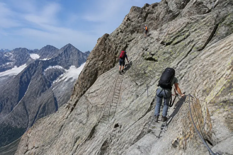 Randonneurs progressant sur un sentier rocheux en montagne le long d'un parcours escarpé vers le lac blanc chamonix