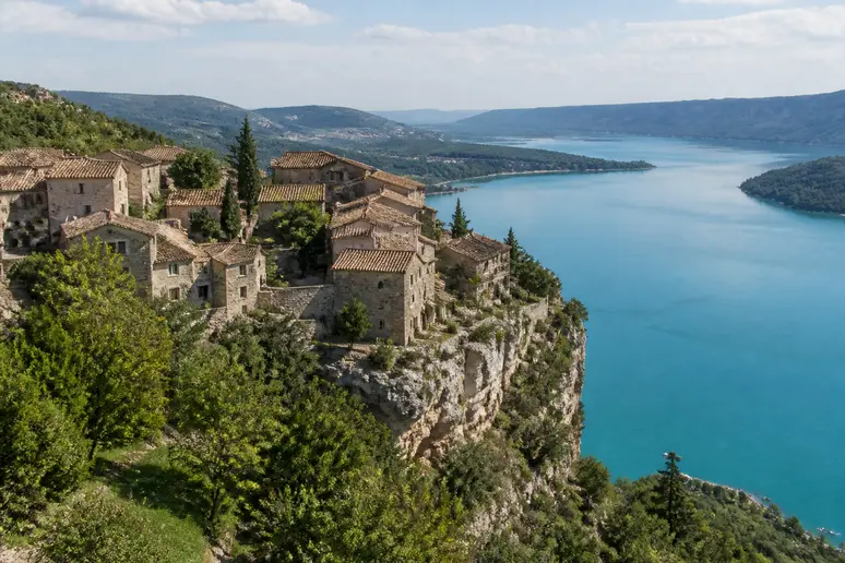 Village provençal perché dominant les rives rocheuses et les eaux turquoise du lac de Sainte-Croix
